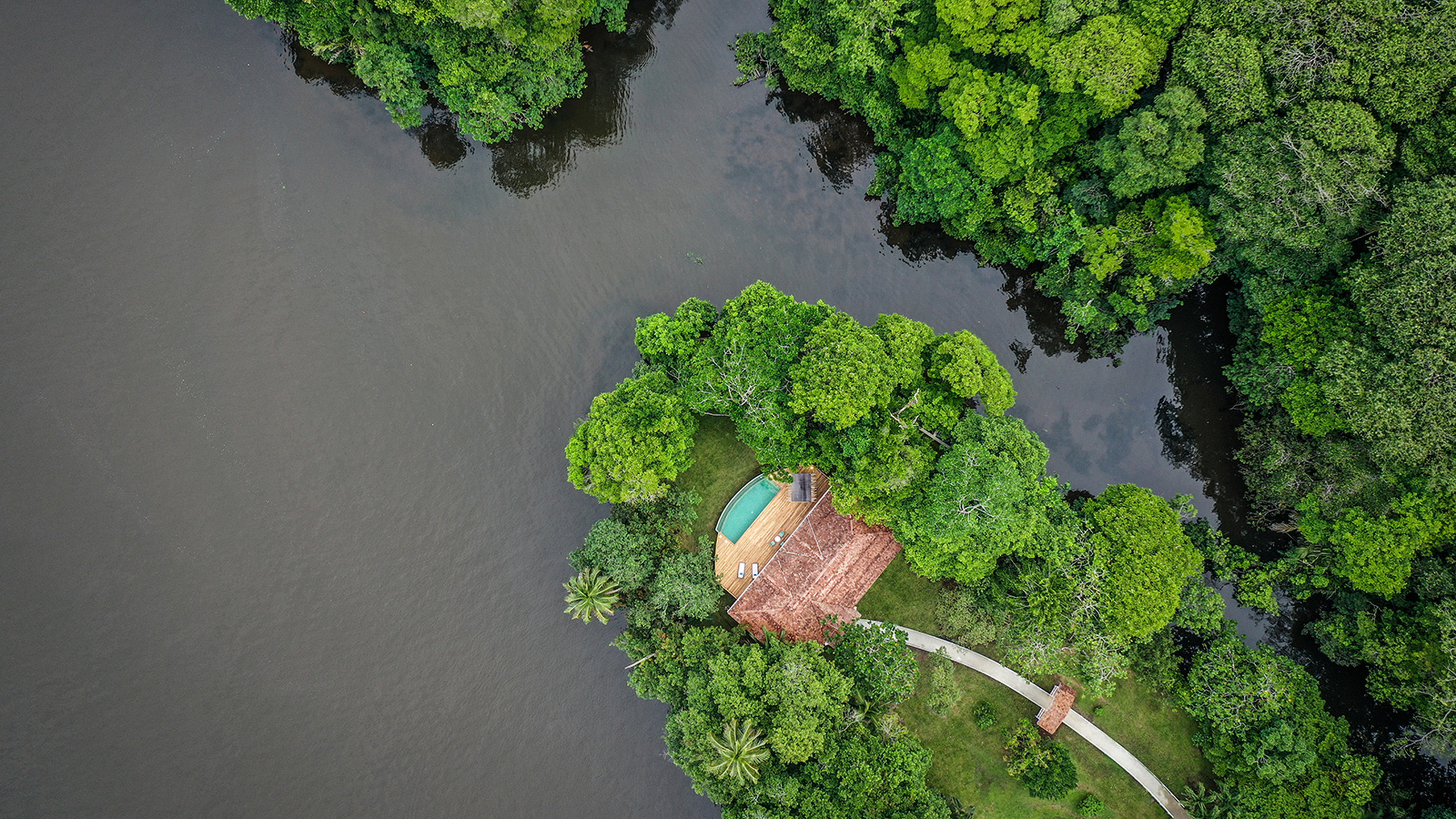 Aerial view of a luxury villa with a pool surrounded by thick jungle at Tortuga Lodge Costa Rica.