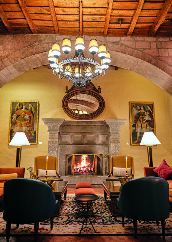 Hotel lounge with fireplace at Belmond Hotel Monasterio, Peru