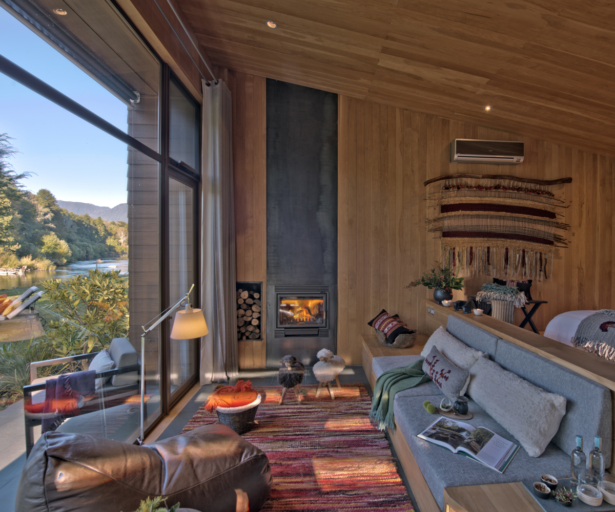 A lounge with a fireplace at &Beyond Vira Vira in Chile