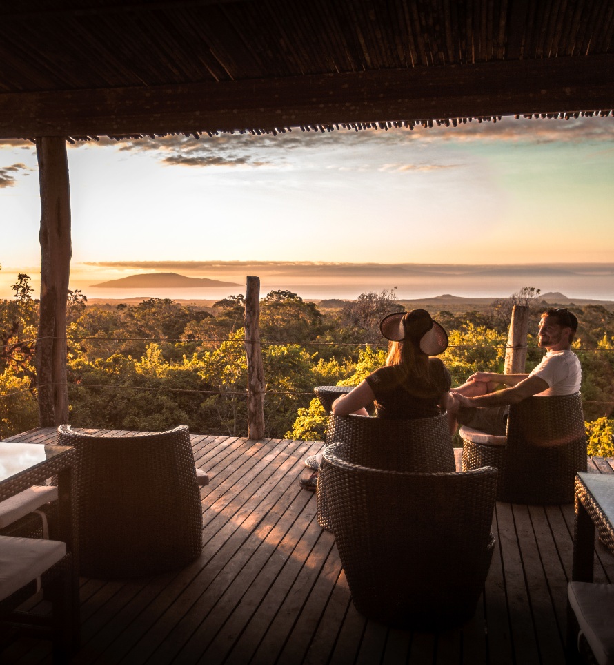 Two people admiring the sweeping views at Galápagos Safari Camp which stretch to the sea.