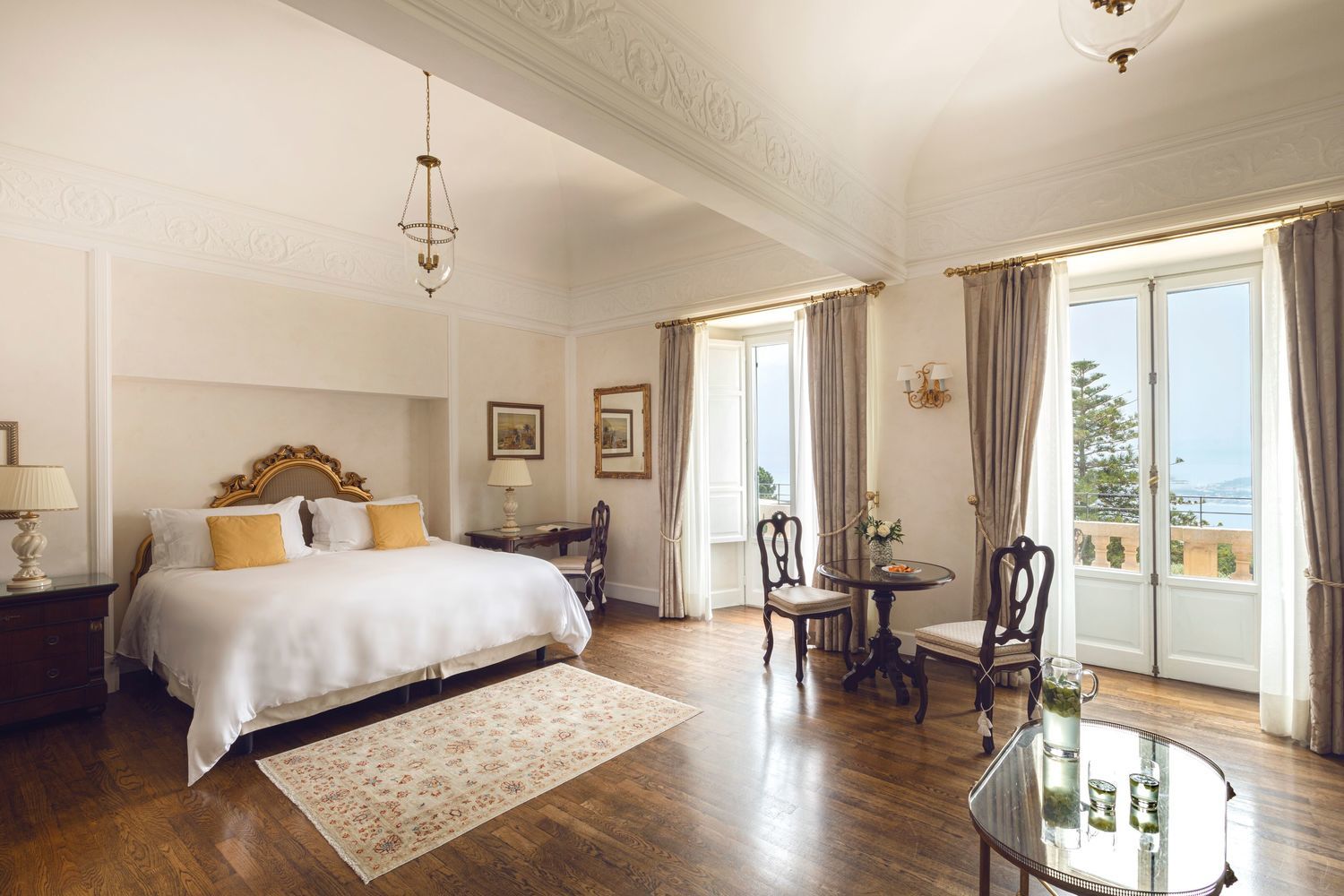 A junior suite bedroom at Belmond Grand Hotel Timeo