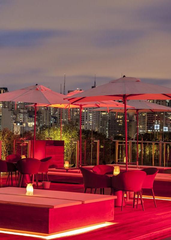 Rooftop restaurant lit up red at night at Hotel Unique