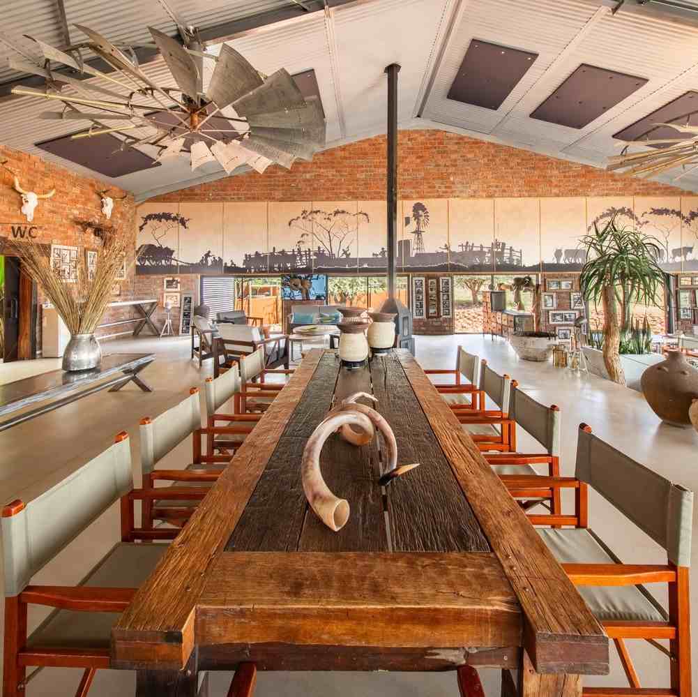 Communal dining room with long table at Okonjima Plains Camp in Namibia