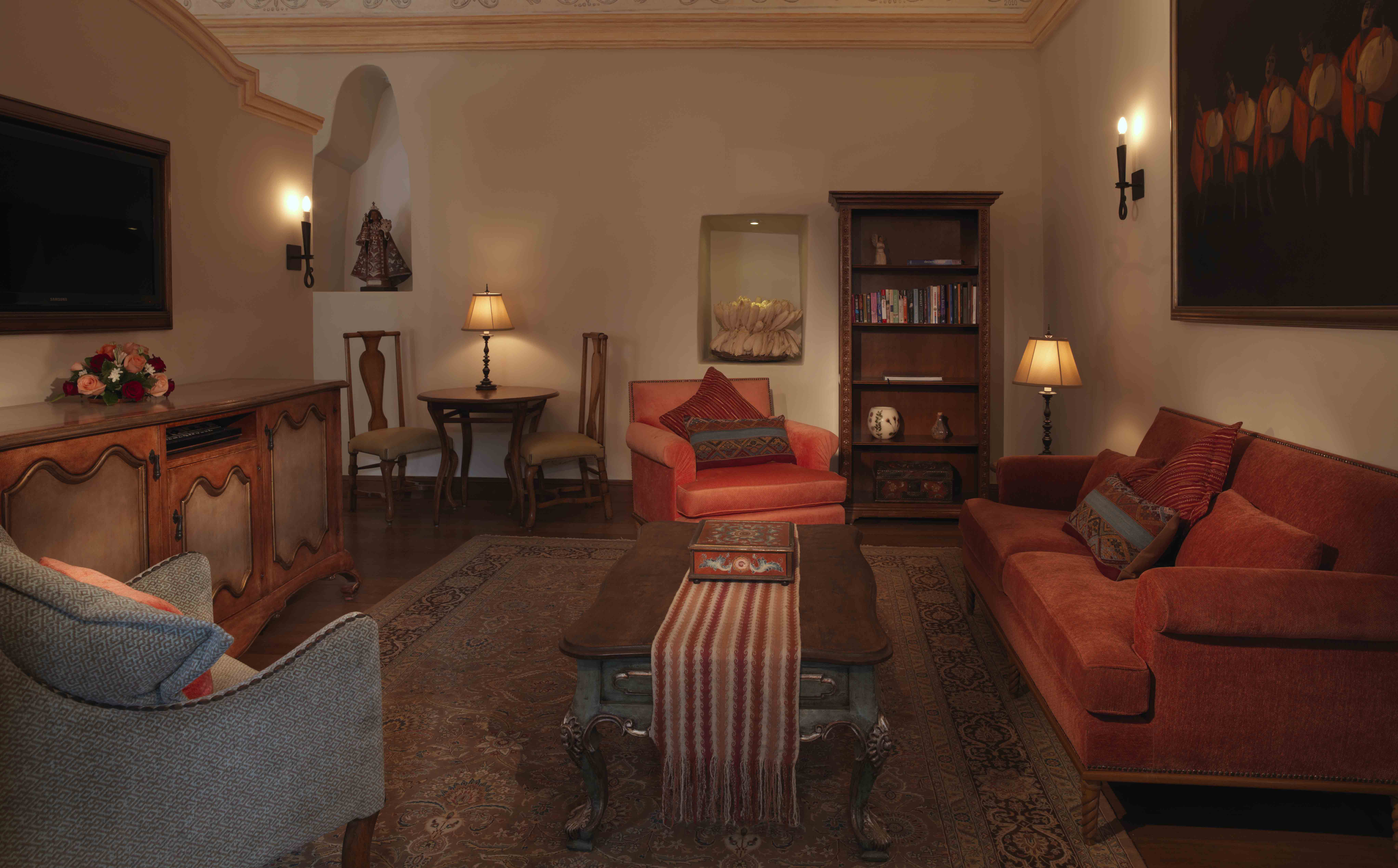 Elegant living room with warm lighting, classic furniture, and decorative artwork.