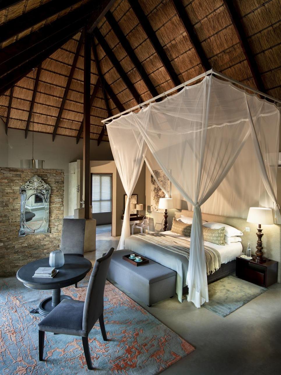 The bedroom of one of Chitwa Chitwa's accommodations featuring a canopy bed.