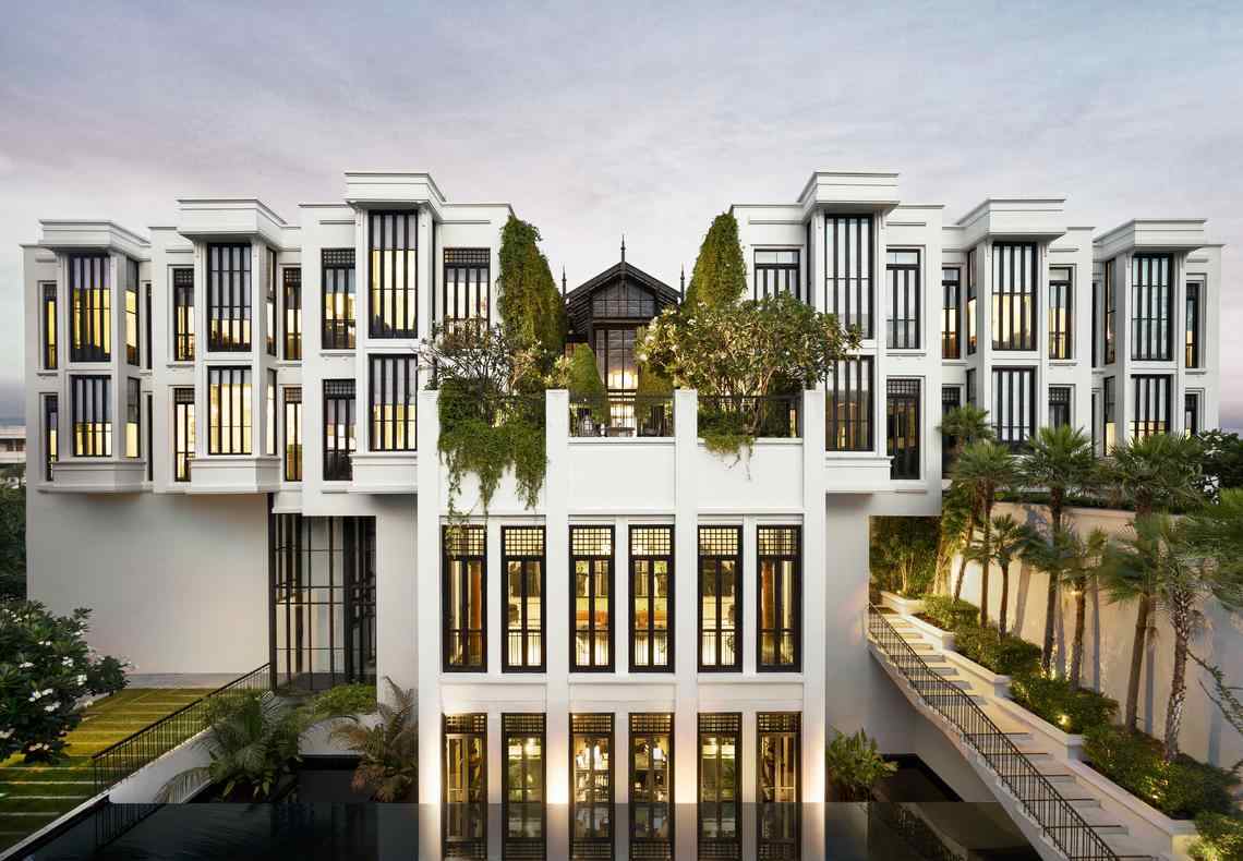 The exterior of the Siam with black accents and green plants growing on the upper terraces.