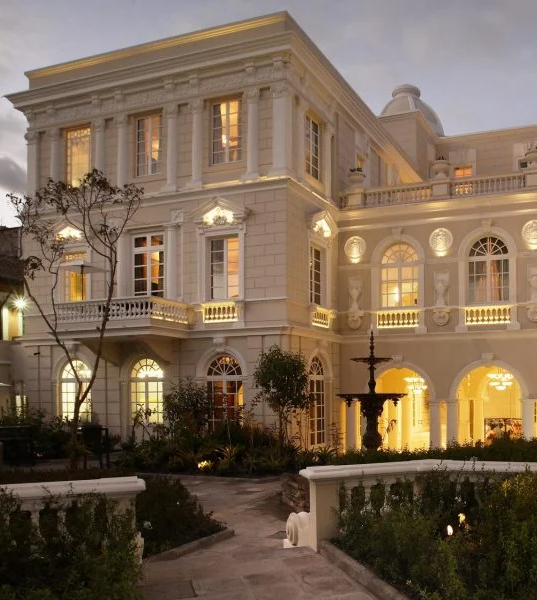 Exterior and patio area of Casa Gangotena illuminated at twilight, Quite, Ecuador