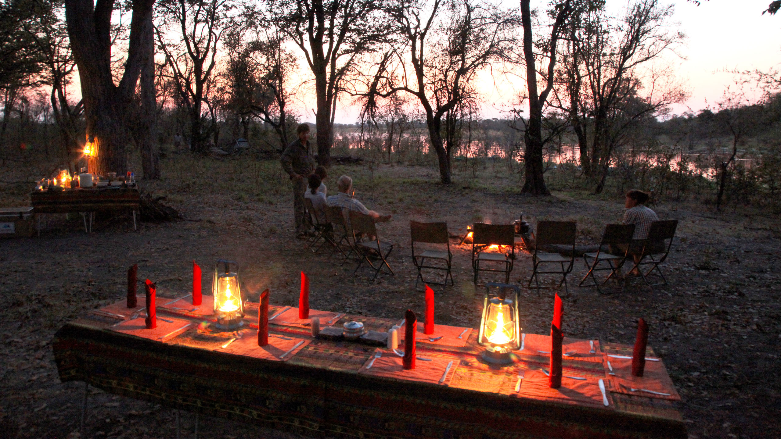 People sitting around a campfire in the African wilderness