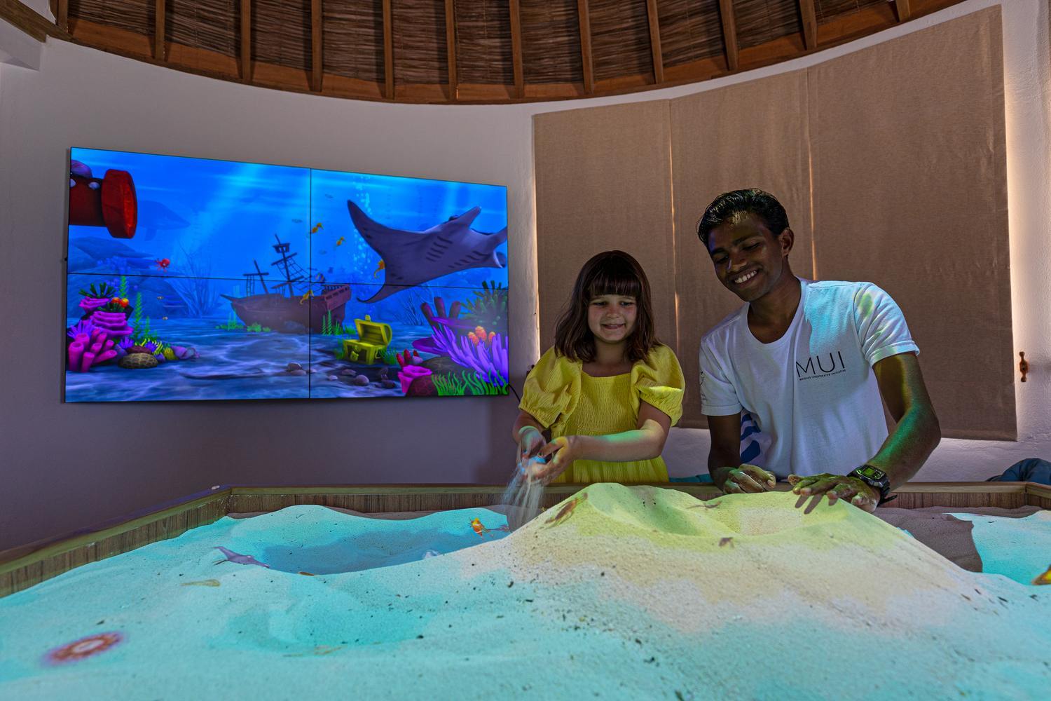 A child enjoying the interactive exhibit at SHELL at Six Senses Laamu