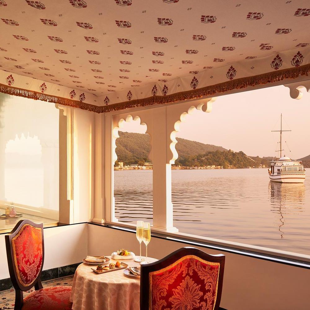 A lake-facing dining area of a suite at Taj Lake Palace.