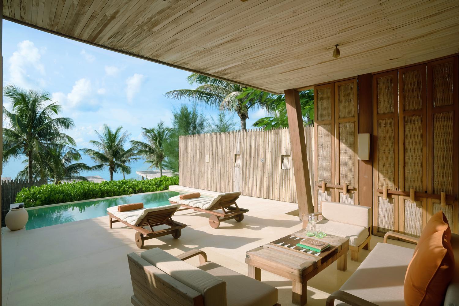 Sun loungers next to the pool at a beachfront pool villa at Six Senses Con Dao