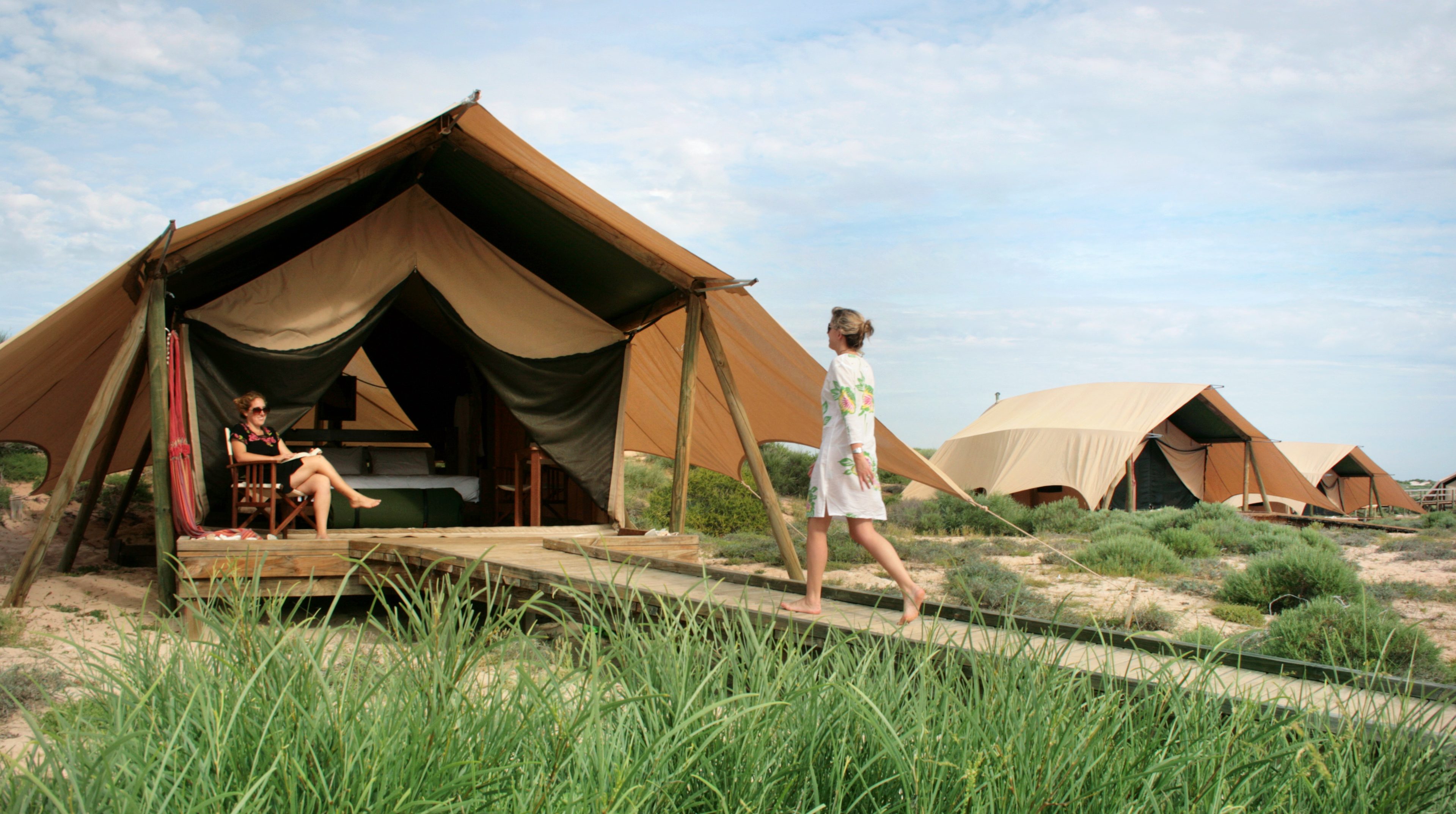 Woman walking into tent, Sal Salis, North West Australia