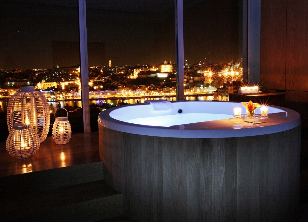 Candlelit bath overlooking the city at night at The Yeatman.