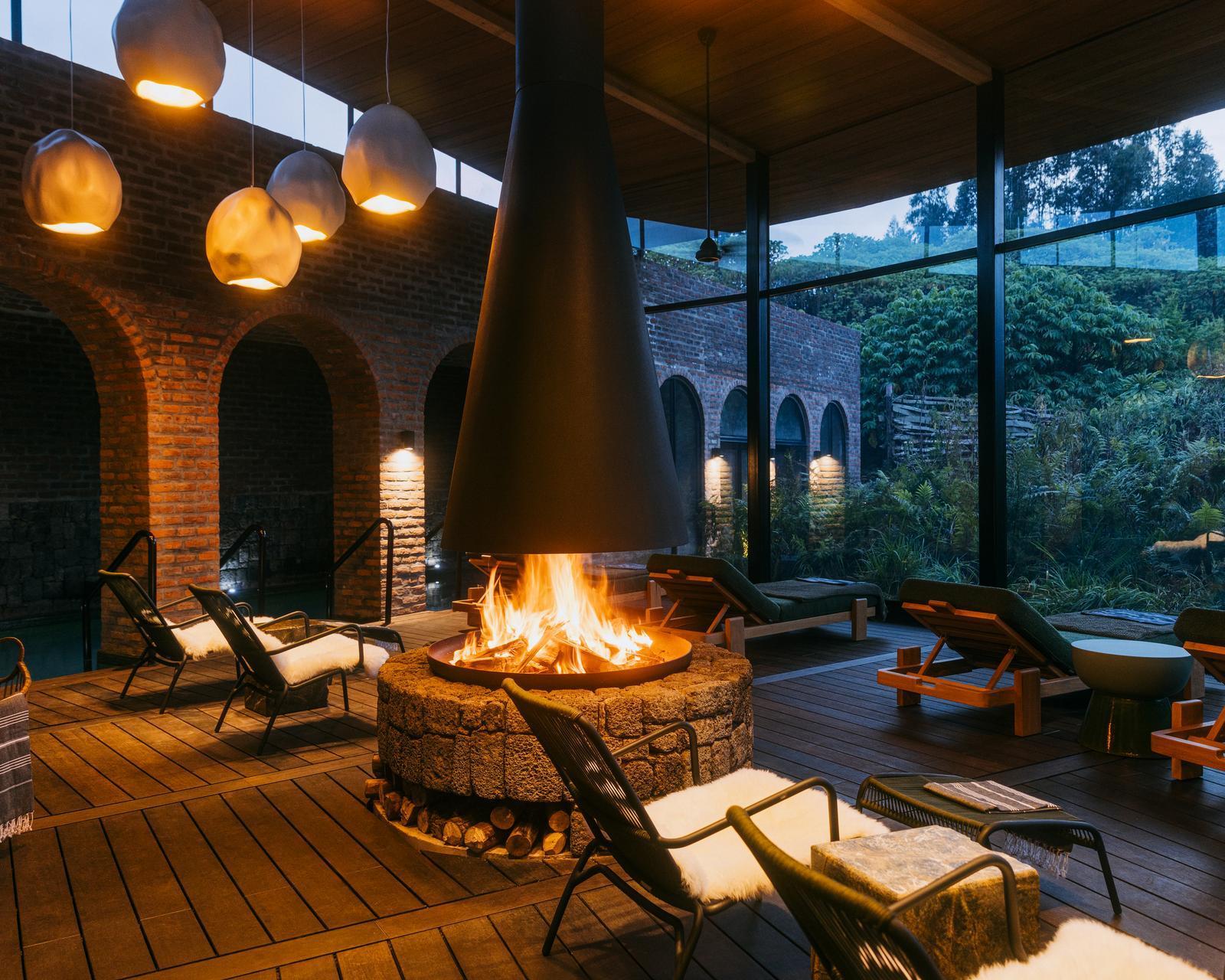 Relaxation space with reclining chairs and fire pit at The Sanctuary at Wilderness Bisate