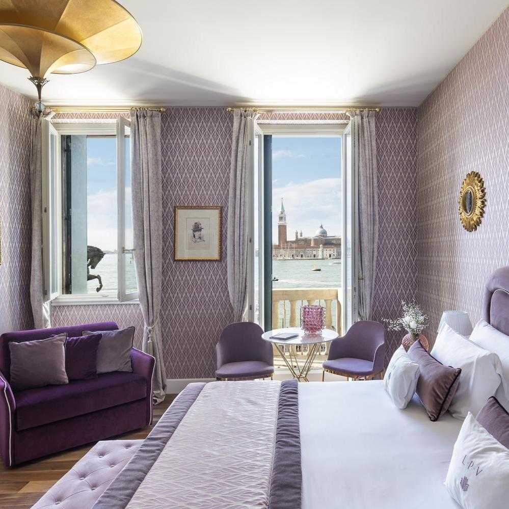 The deluxe bedroom with a lagoon view at Hotel Londra Palace in Venice.