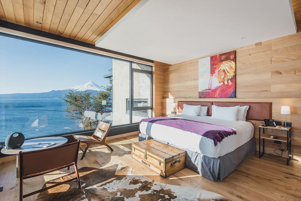 The bedroom of one of Hotel AWA's rooms overlooking the lake.