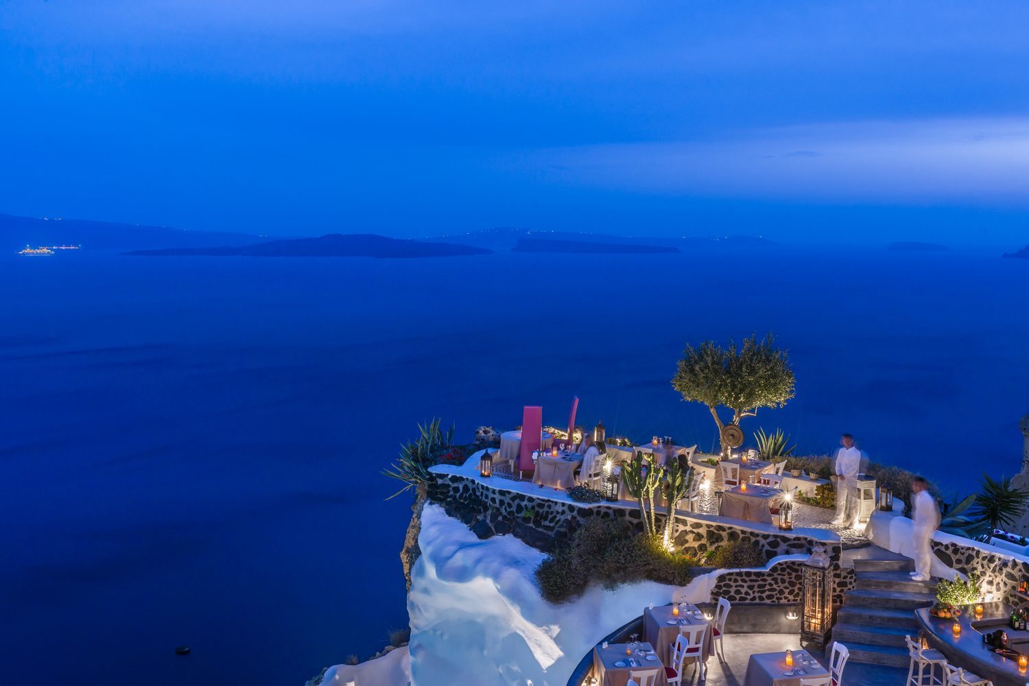 Private dining set up with ocean views at Andronis Luxury Suites