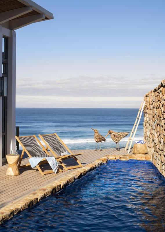 The outdoor pool with deck chairs at Lekkerwater Beach Lodge, South Africa