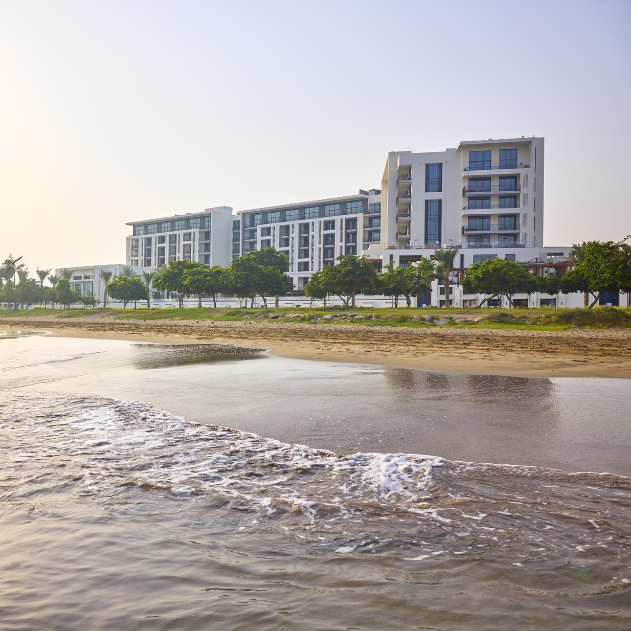 The exterior of Mandarin Oriental Muscat from the coast.