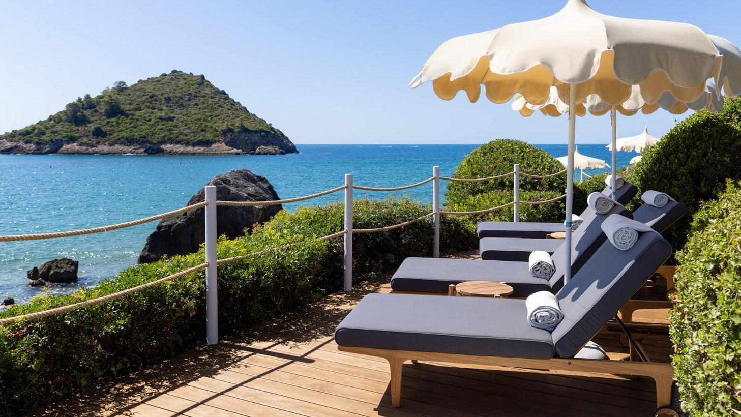 Sun loungers at La Roqqa's beach club overlooking the sea.
