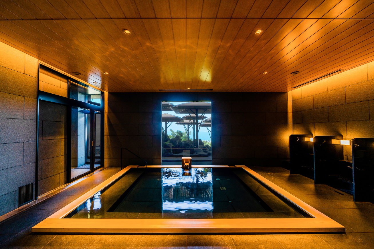 An indoor spa bath with deep golden lighting