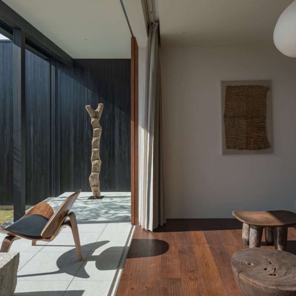 Modern hotel room with a sunny covered terrace and an indoor area separated by a curtain