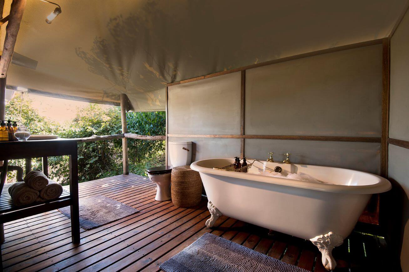 Clawfoot bathtub in an open-air tented bathroom