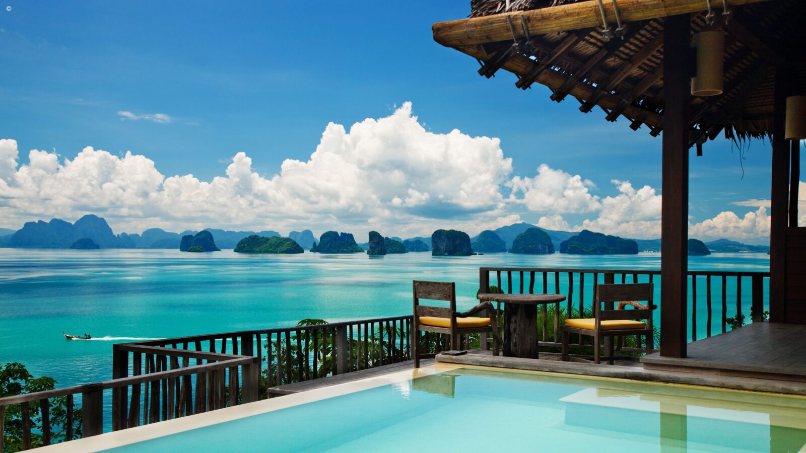 Private infinity pool and balcony overlooking a tropical bay for luxury Asia honeymoons.