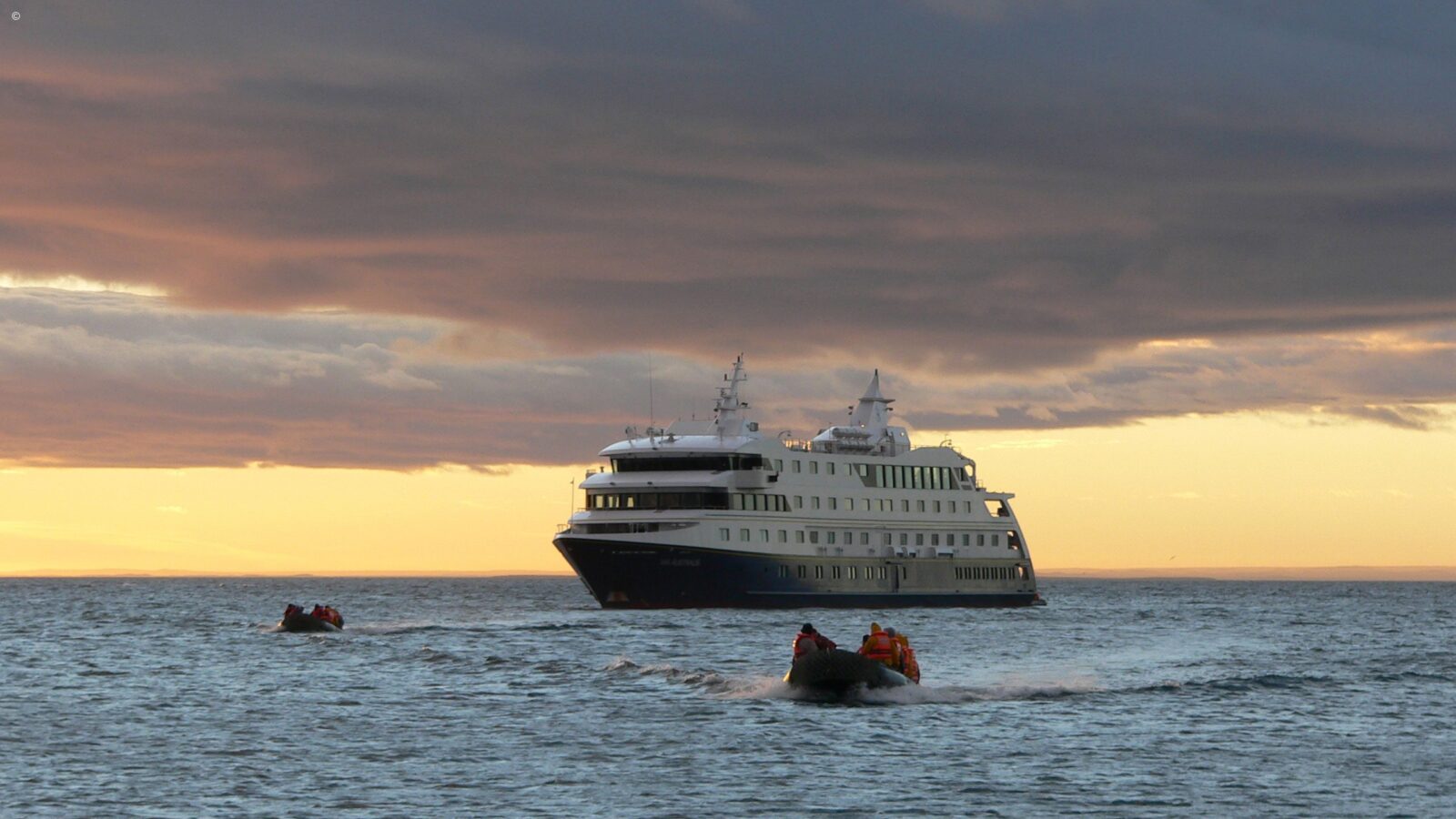 Expedition ship off Cape Horn at sunset