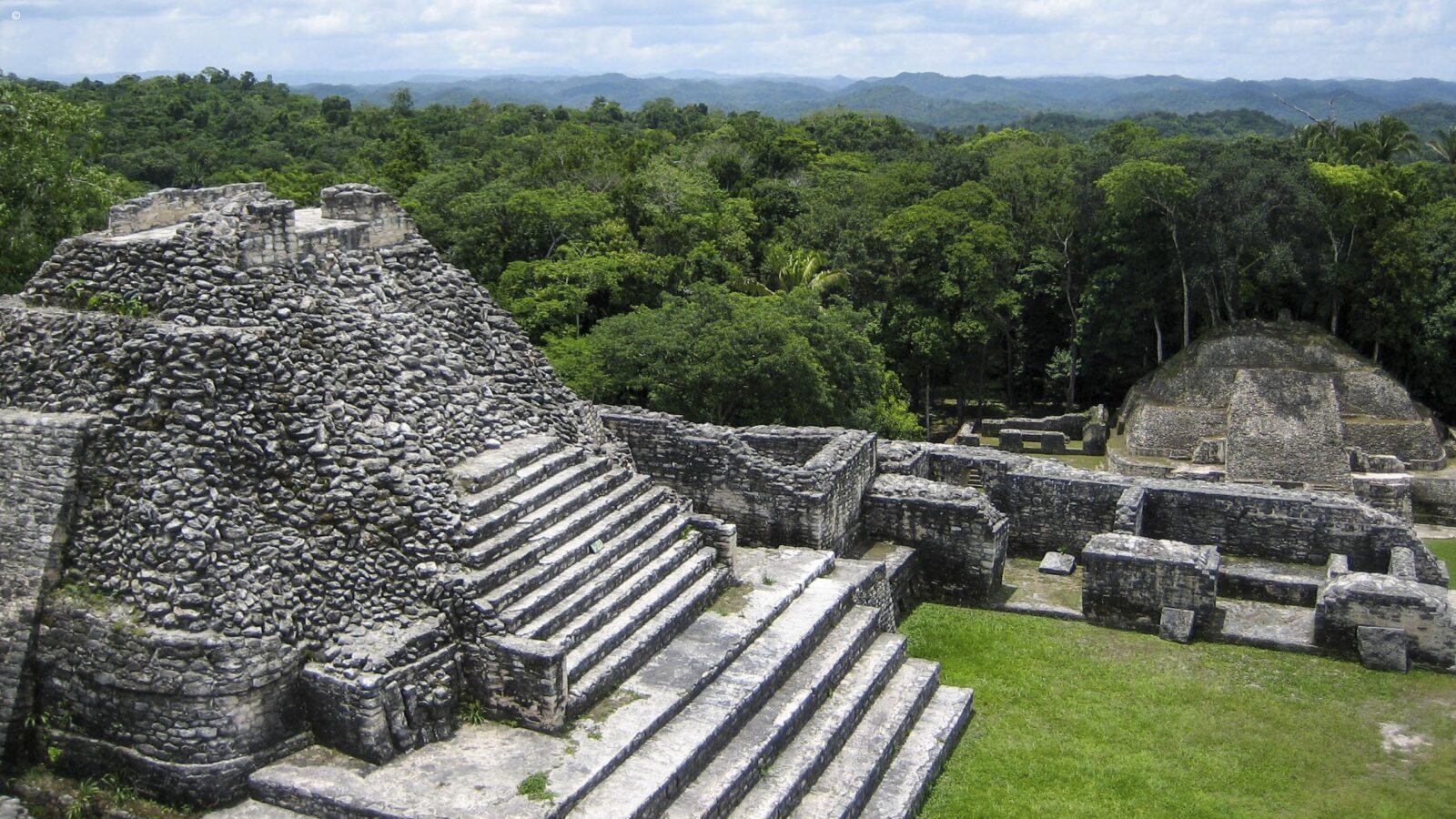 Ancient Mayan stone ruins in the jungle during luxury Belize tours.
