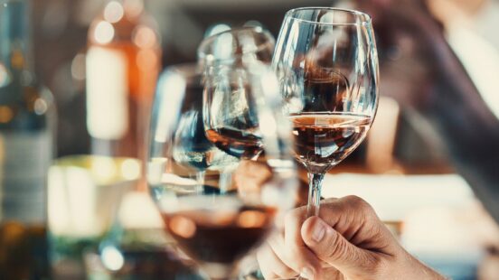 People clinking wine glasses