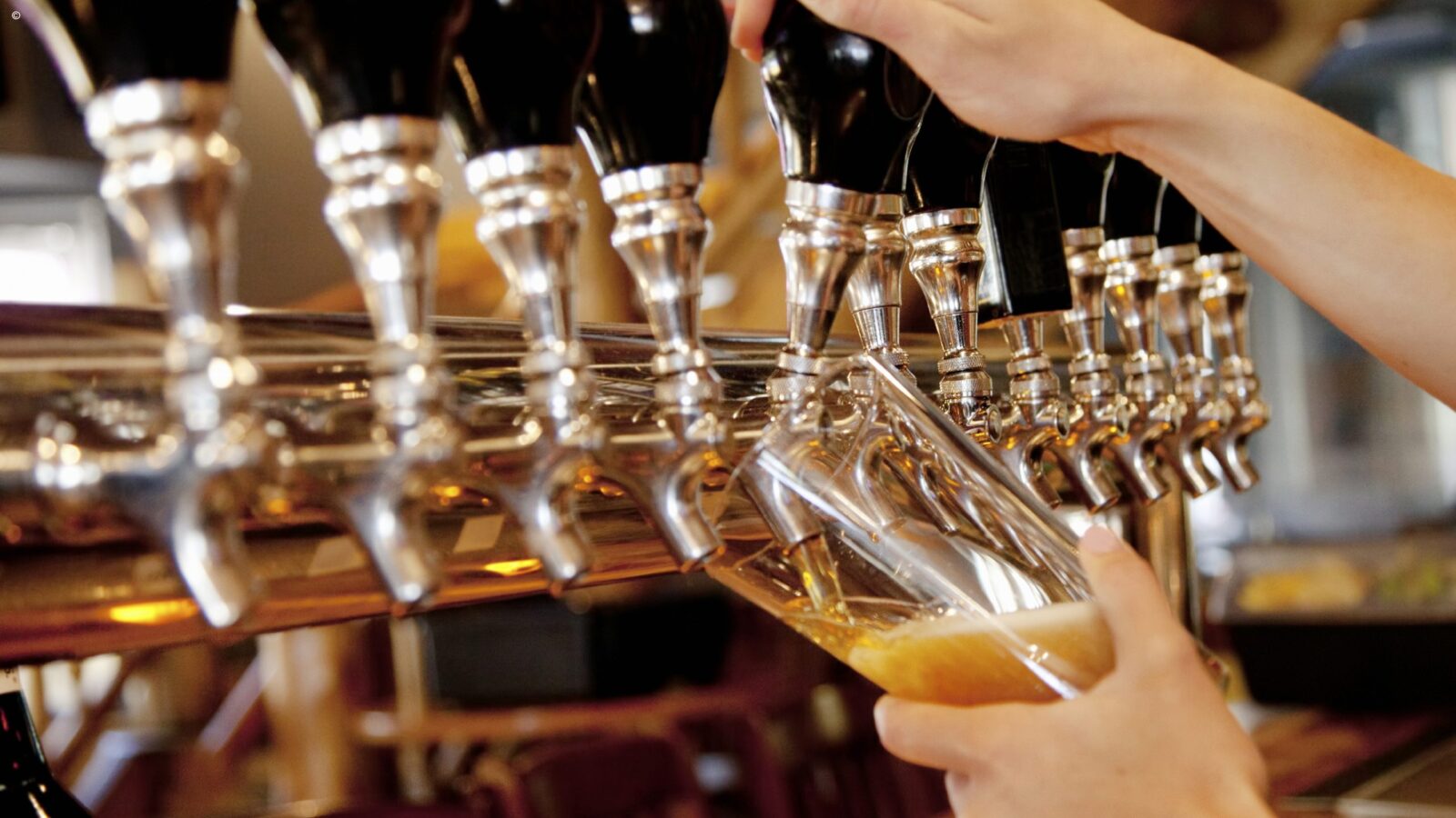 Close up of a woman pouring beer a a bar