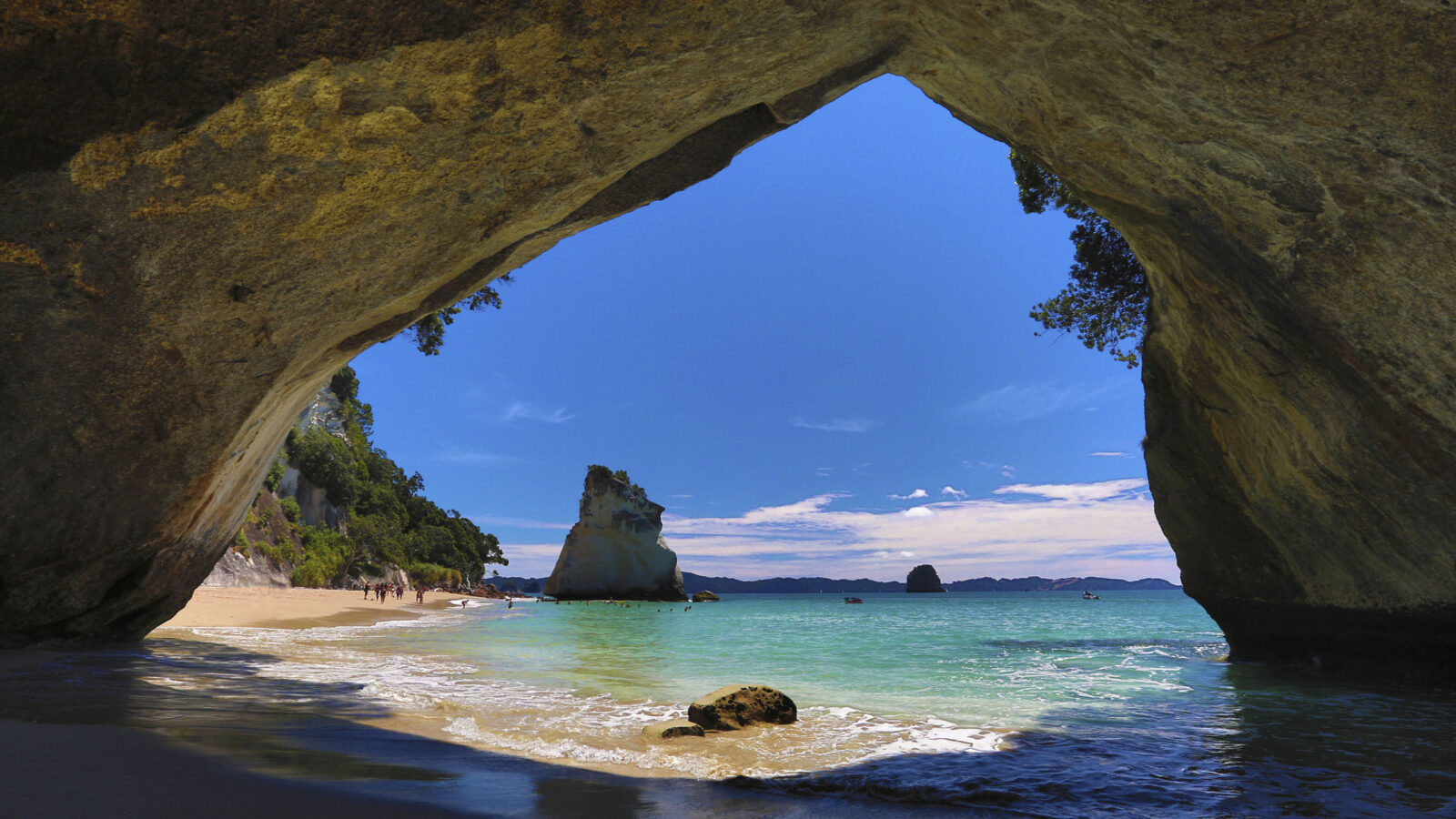 View of Cathedral Cove looking out onto ocean and blue sky