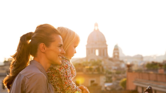 A mother and daughter viewing a cathedral dome at sunset during luxury Europe family tours.