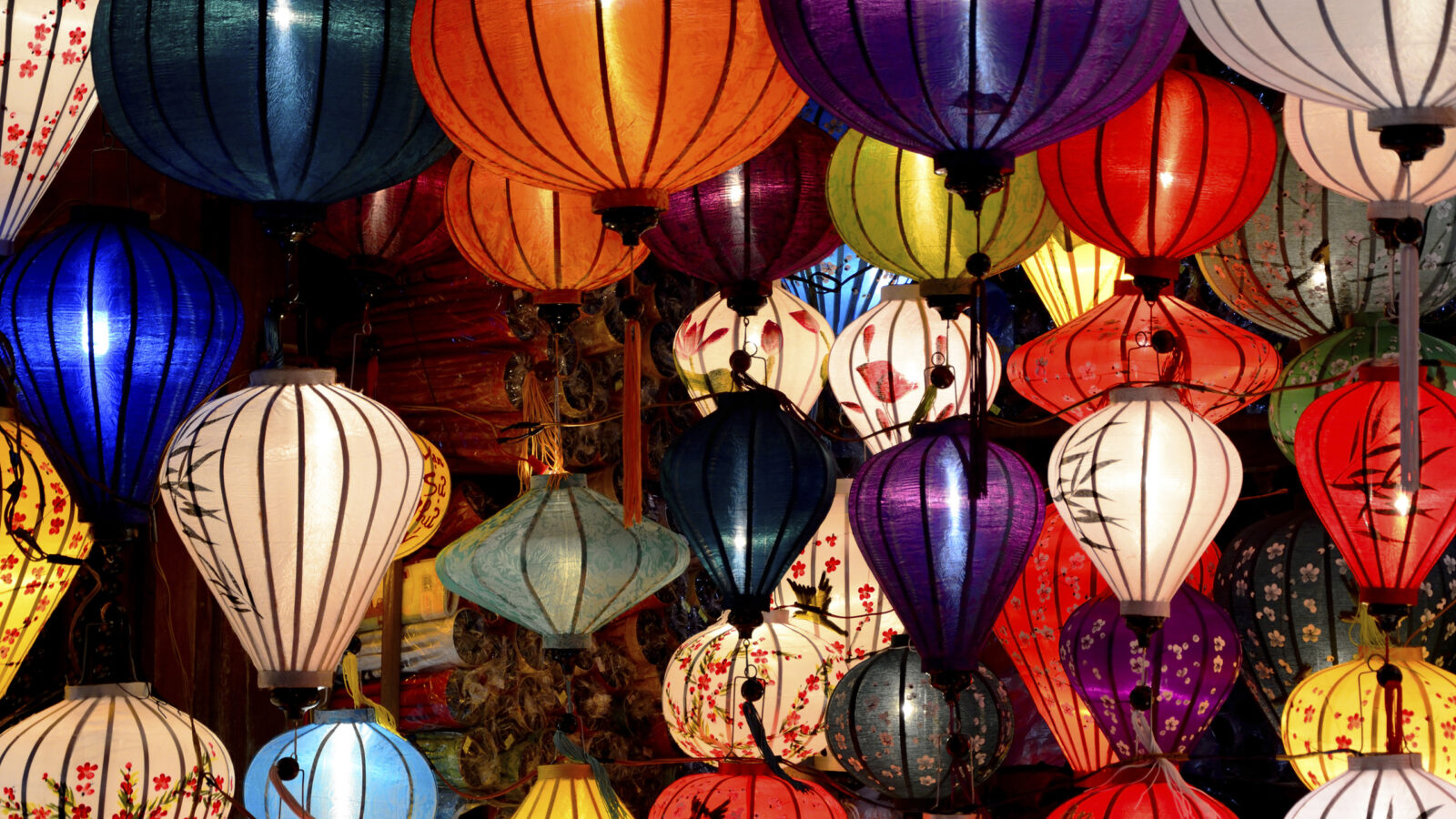 A dense collection of colorful glowing silk lanterns for luxury Asia honeymoons.