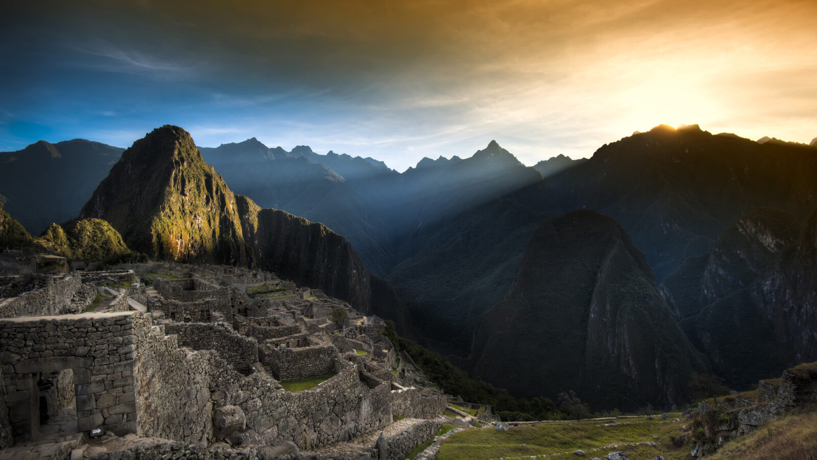 Sunrise over the stone ruins of Machu Picchu during luxury Latin America honeymoon tours.