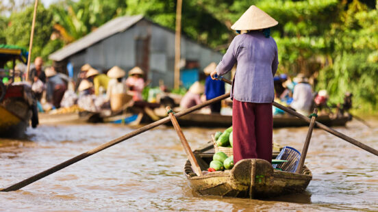 vietnamese-woman-rowing-boat-mekong-vietnam