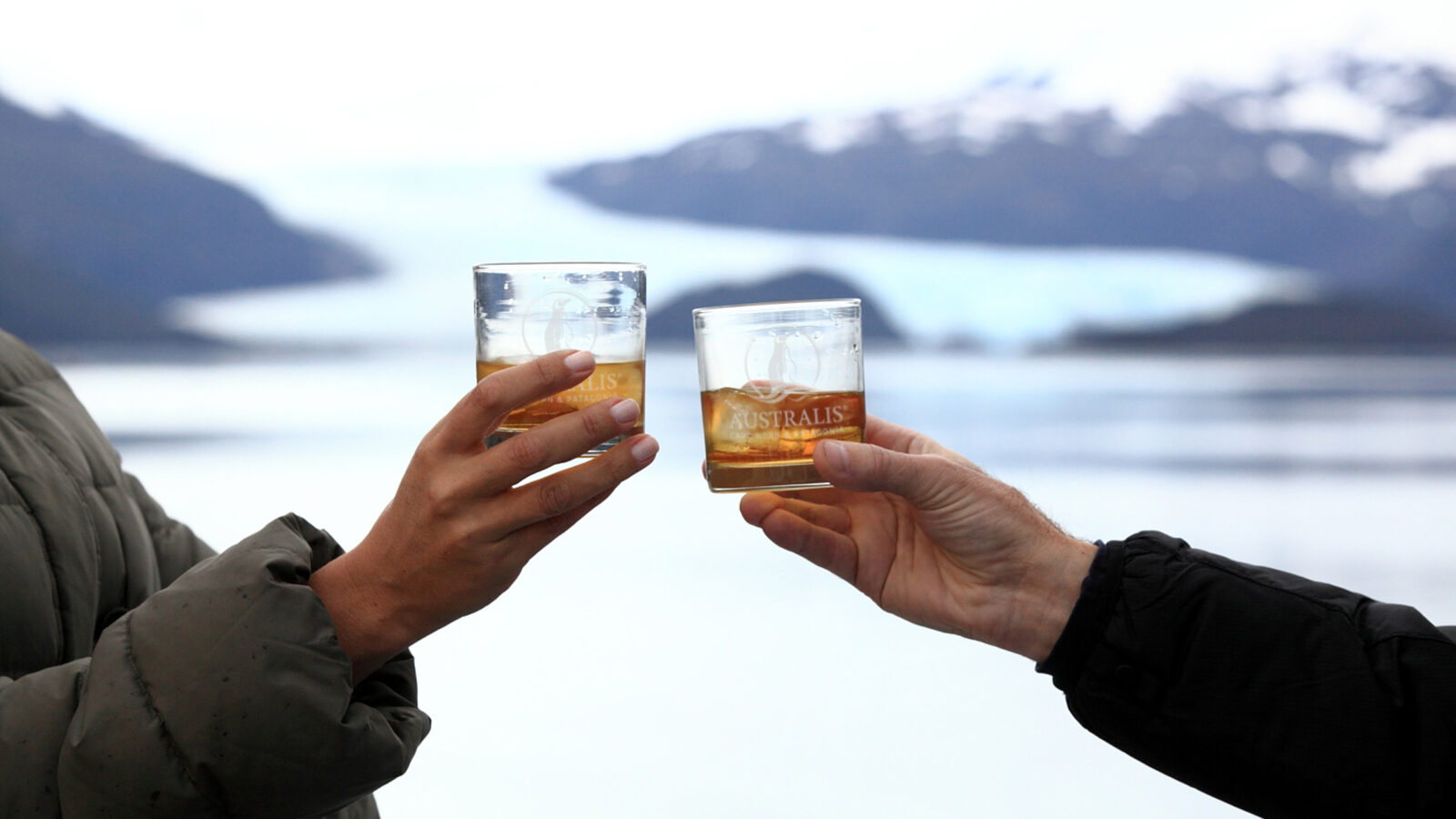 Guests raising drinks on deck during a Cape Horn cruise