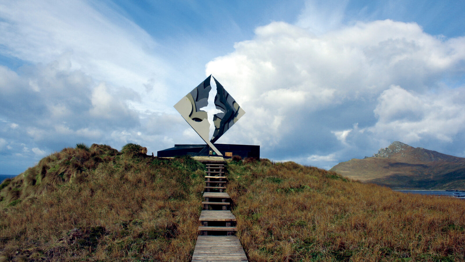 Cape Horn monument on a grassy hillside
