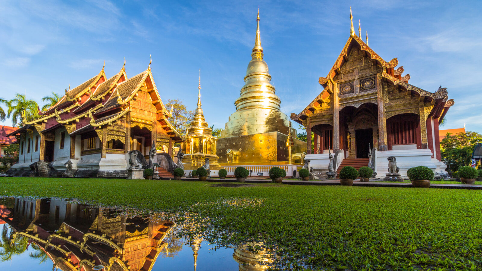 Wat Phra Singh temple and reflection in water. Chiang Mai