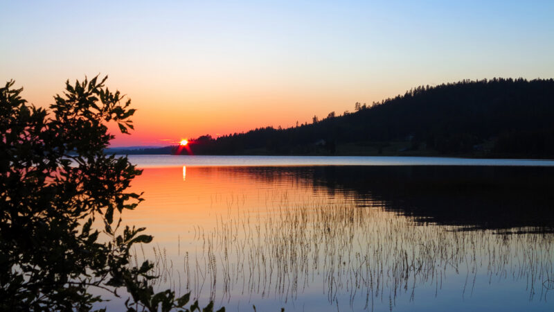 A summer picture with midnight sun on a lake