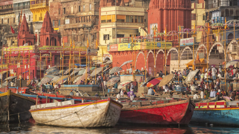 Varanasi is a city on the banks of the Ganges in Uttar Pradesh. The Ganges is a trans-boundary river of India and Bangladesh. Indian Hindus and tourists from all over the world in the boats and riverside of Ganges in early morning. Every morning Indian people are coming to riverside for praying and worship. The Ganges is the most sacred river to Hindus.