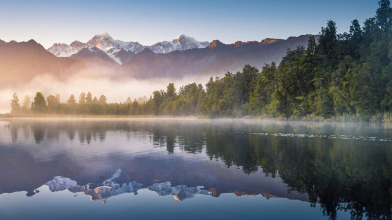 Mount Cook and Mount Tasman reflected in Lake Matheson at Sunset. New Zealand