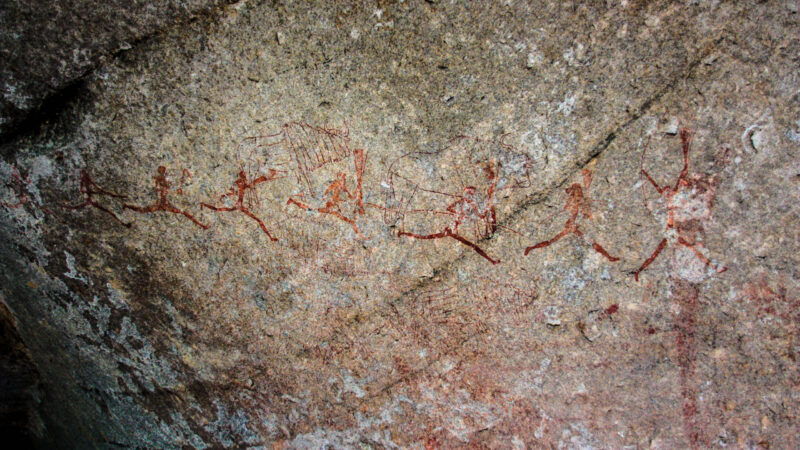 Ancient rock paintings of human and animal figures in a cave in the Matopos National Park, Zimbabwe.
