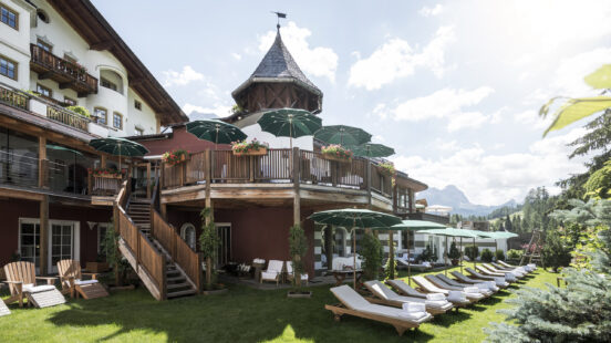 Exterior of Rosa Alpina, row of sun loungers on a summerx27;s day, San Cassiano Italy
