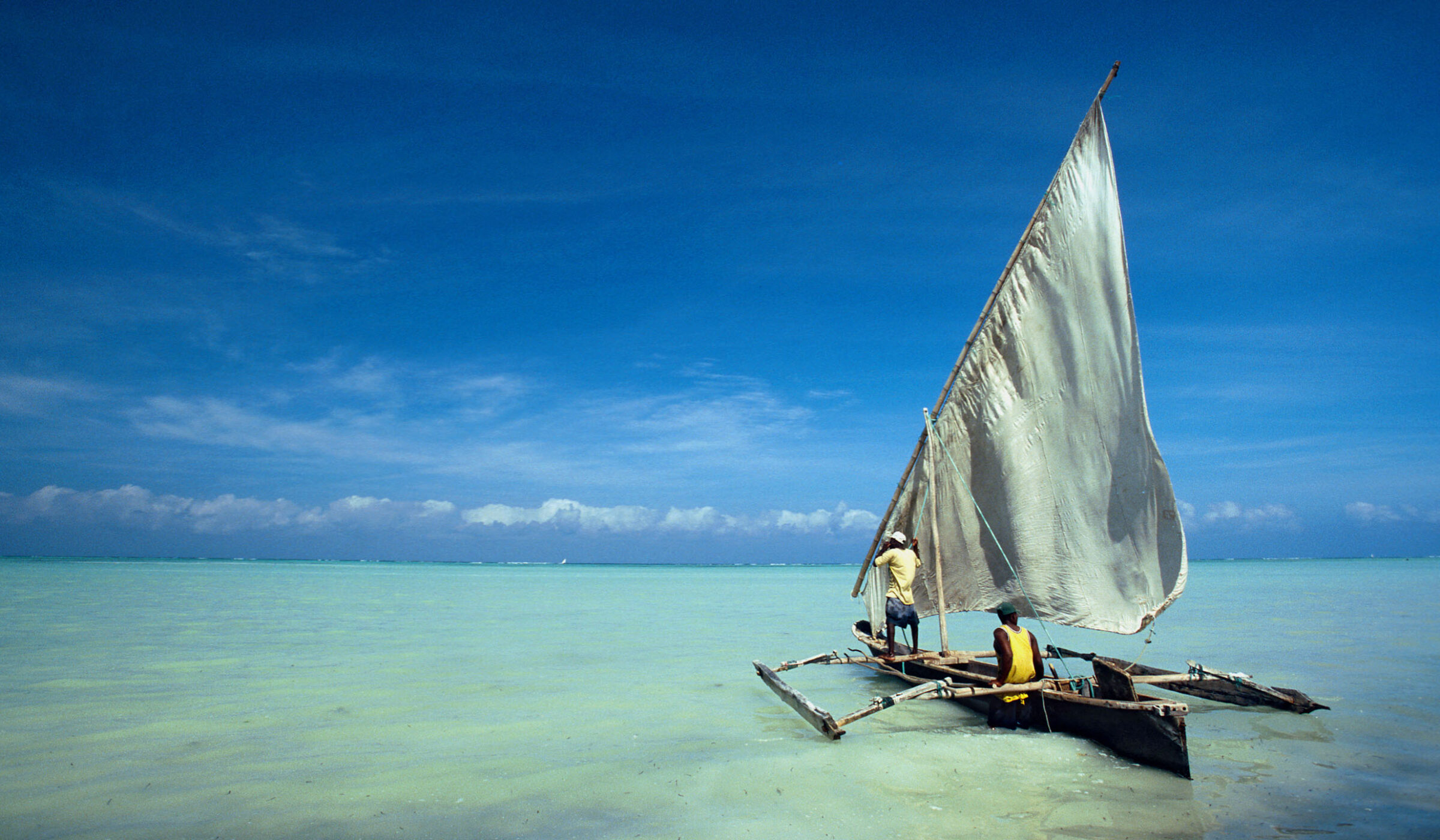 Dhow in the crystal turquoise waters of Zanzibar, Tanzania
