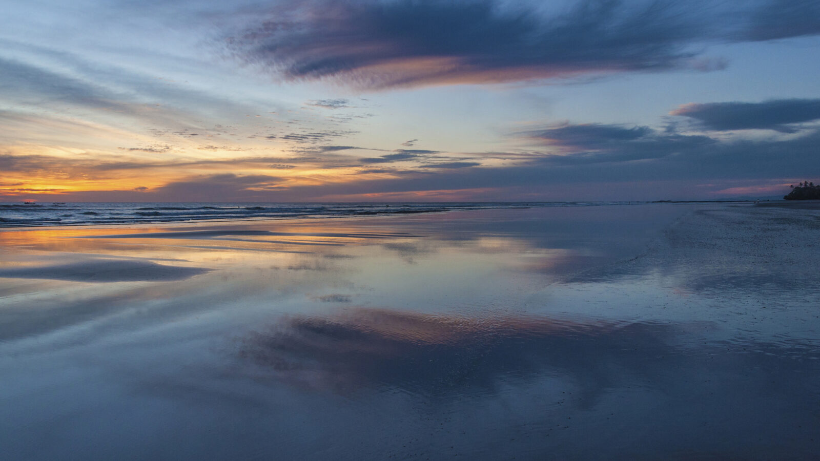 Low tide at sunset over a sandy beach