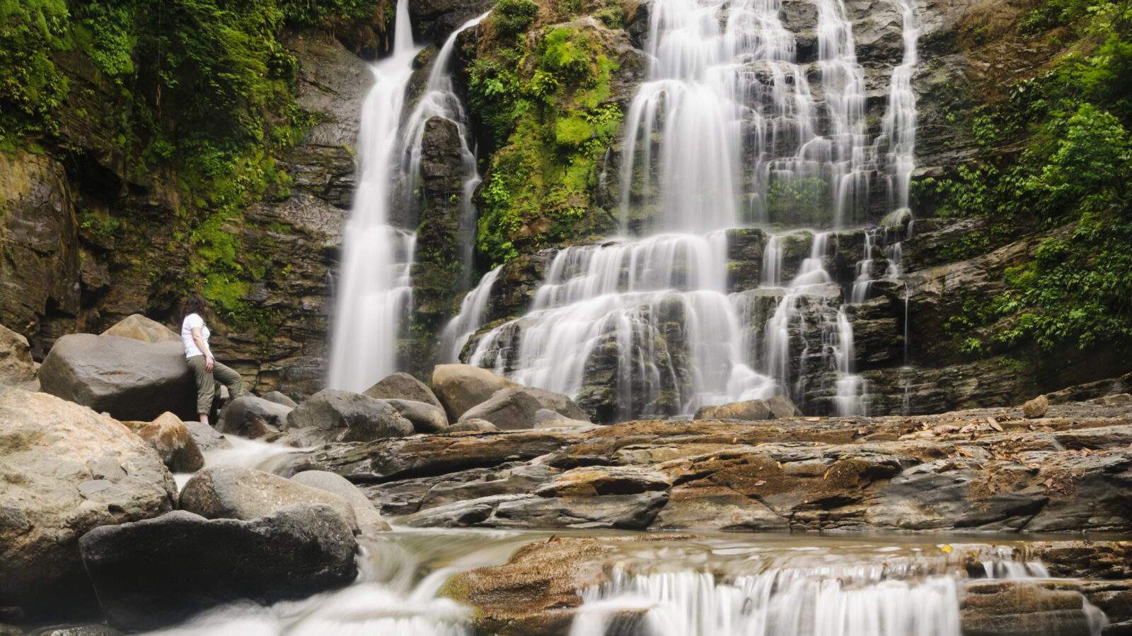 Traveller watching Nauyuca Waterfall, Dominical, Costa Rica.