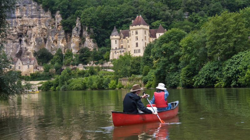 Young people canoing on the Dordogne River in France, past medieval castles and striking ancient cliffs. The lad in the back of the canoe holds a small camera. The couple in the canoe are my son and my wife, who would be excited to see their photo in use. I would appreciate it if anyone using this photo could pm me to say where it is used. Thanks