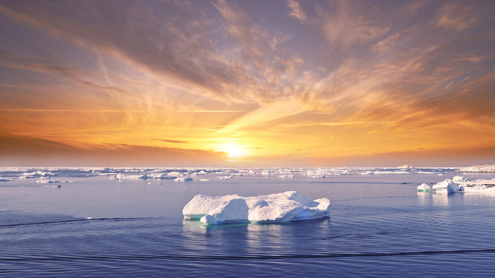 Sunset strikes the icebergs near Ilulissat